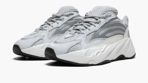View of white and grey Yeezy shoes.